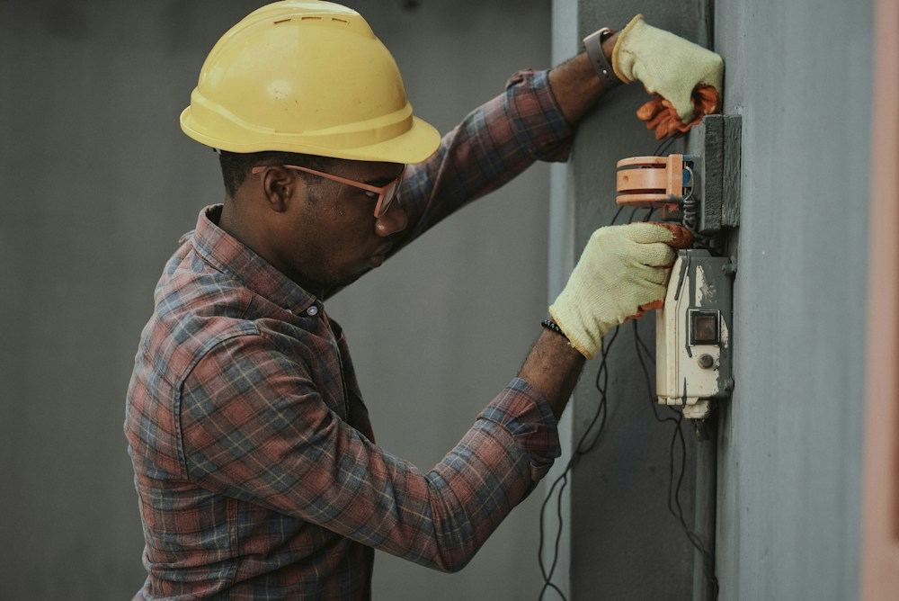 A field technician working at a utility meter